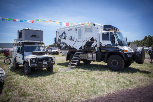 Flagstaff, Arizona USA - May 16, 2014: A Land Rover and a Unimog are parked next to each other at the Overland Expo in Flagstaff, AZ. Both vehicles are set up for long range adventure and camping. The Overland Expo is a three day gathering every year of like minded individuals that talk about adventures and round the world travel.