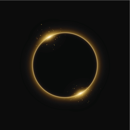 Solar eclipse in golden light in black background.