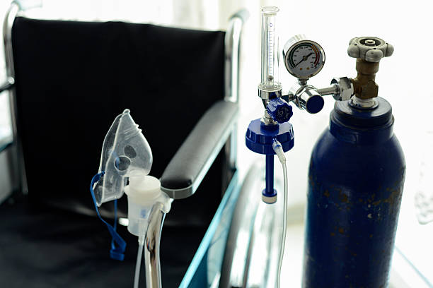 Medical Oxygen Tube Close-Up Image Of Medical Oxygen Tube And The Wheelchair Behind It. medical oxygen stock pictures, royalty-free photos & images