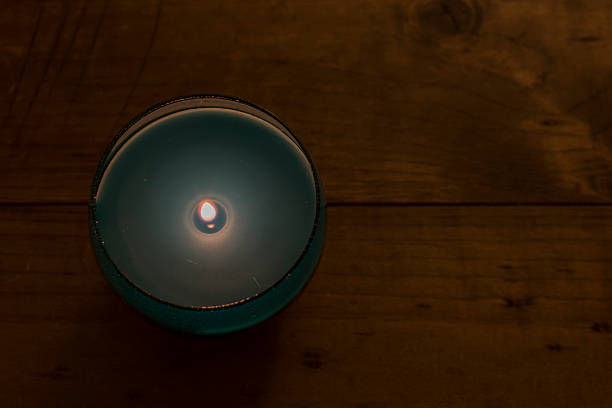 istock Blue Glass Candle on Wooden Table 503139668