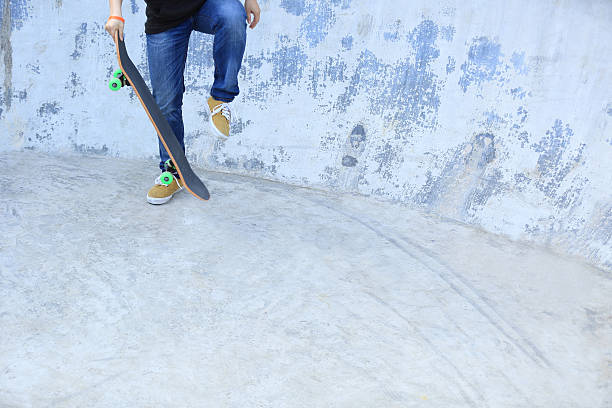 istock skateboarding legs at skatepark 503140450