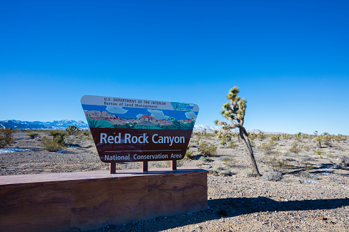 Las Vegas, USA - December 26, 2015: Red Rock Canyon sign in the Nevada desert. Photographed with the Canon 5DSR during winter so snow can be seen in the background. 