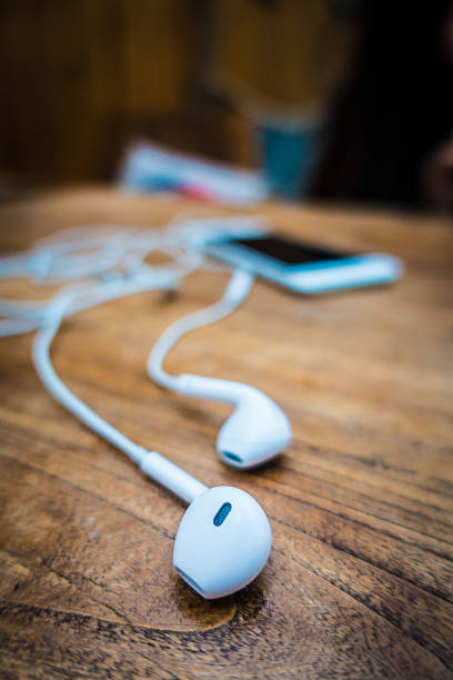 istock mobile phone and headphones lay on wooden table 503141596
