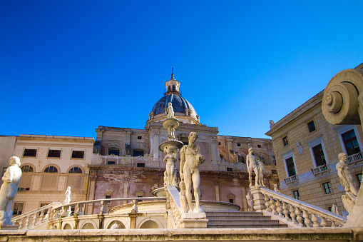 The Fontana Pretoria (by Florentine sculptor Camilliani, dating from 1575), backdropped by a vibrant blue sky. Shot in Palermo, Sicily, Italy. Copy space in the sky.