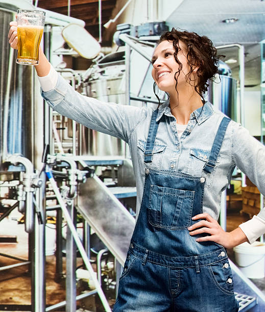 istock Smiling female brewmaster holding glass in industry 503143032