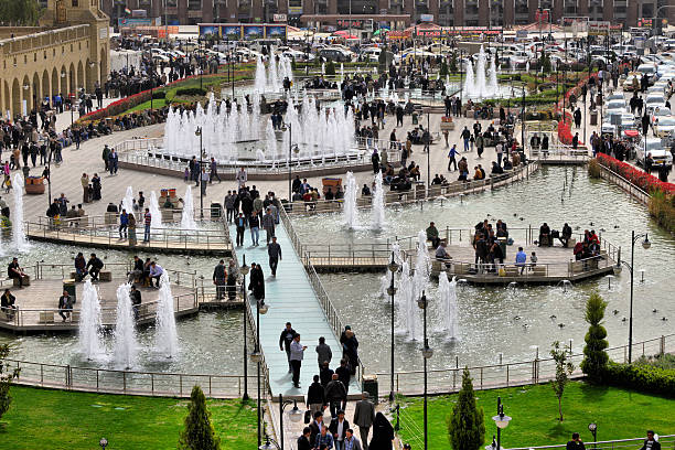 Erbil / Hewler / Arbil / Irbil, Kurdistan, Iraq: the city's busy and popular main square, Shar Park, with crowds enjoying the pleasantly cool area created by the fountains - seen from the Erbil citadel - photo by M.Torres