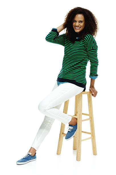 istock Cheerful woman sitting on stool & looking at camera 503147713