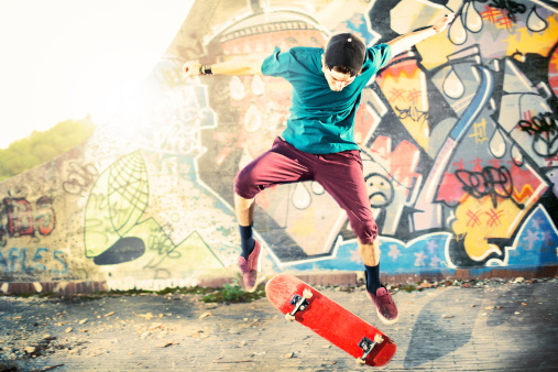 Skater in movement making a trick with his skate in urban place