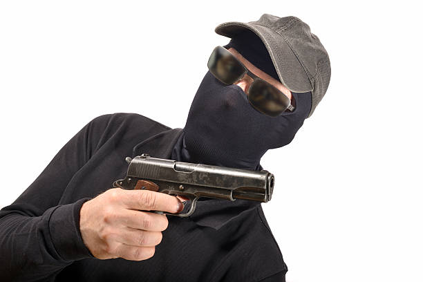 istock hooded man with a gun 503153169