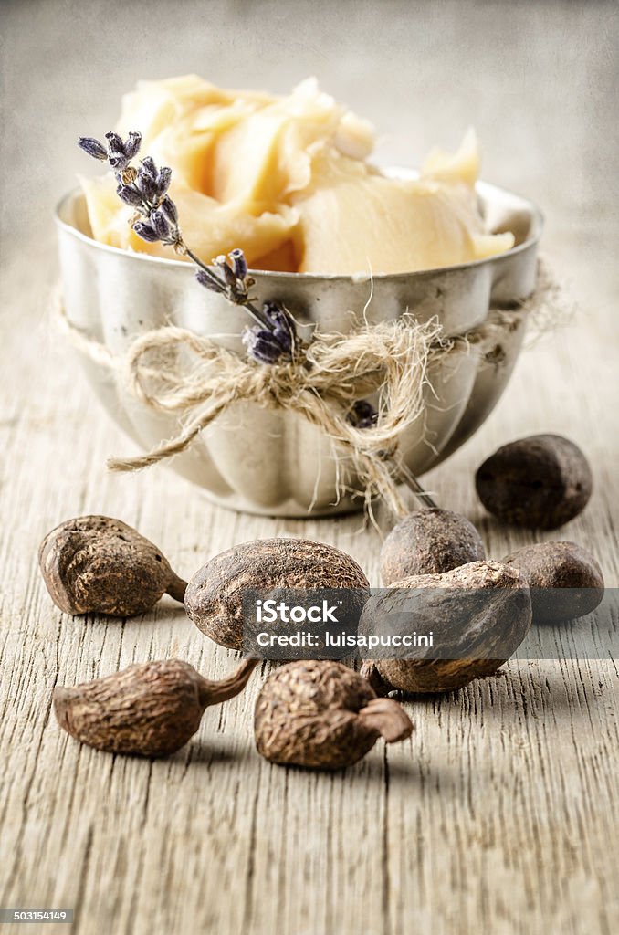 Shea nuts and butter shea nuts with a cup of shea butter. Shallow depht of field Beauty In Nature Stock Photo