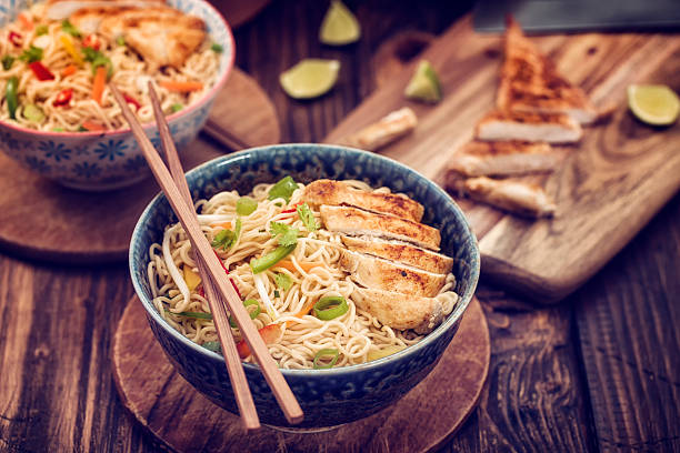 fideos con pollo salteado - comida asiática fotografías e imágenes de stock