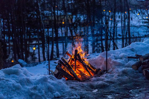 Bonfire at night in the winter forest