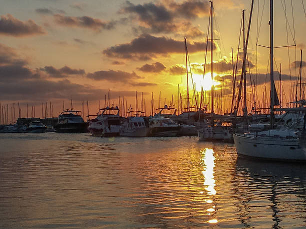 istock Sailing ships in port at sunset with red sky 503159158