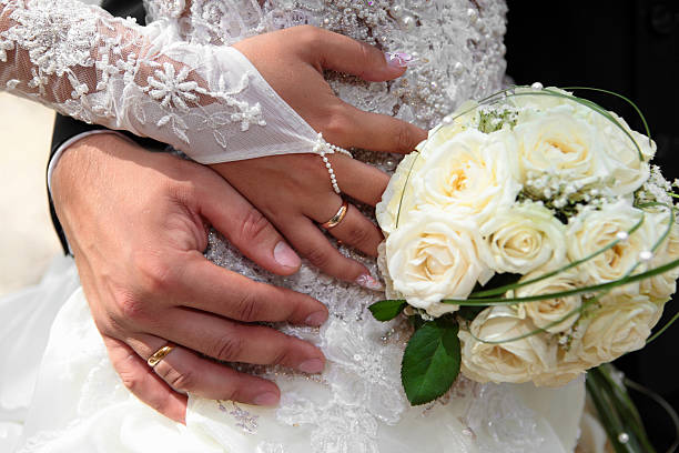 istock Hands and rings on wedding bouquet 503160666