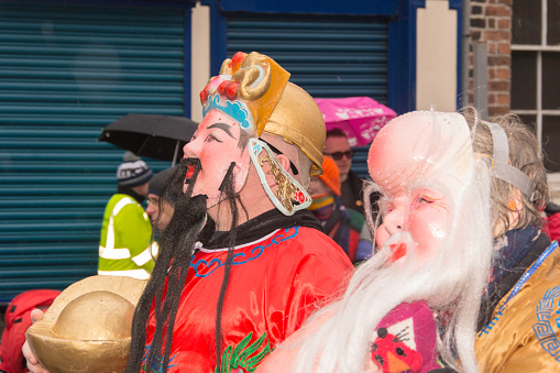 Liverpool, England - February 22, 2015: Liverpool Chinese New Year.  Symbol of the the year the goat or ram.  Event staff in fancy dress as traditional chinese characters
