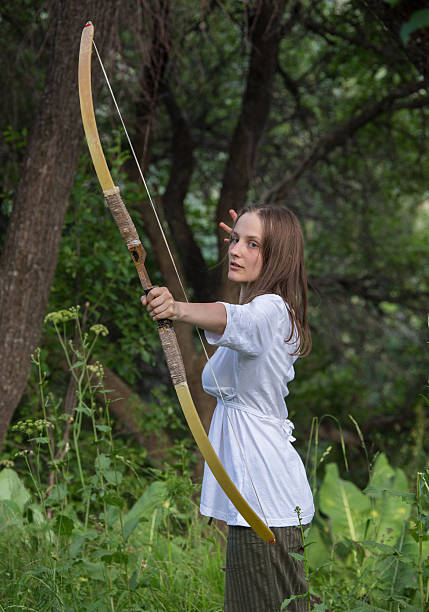 istock Beautiful woman drawing a bow 503163468