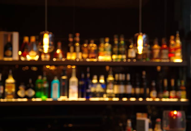 istock blur alcohol drink bottle at pub in dark night 503164066