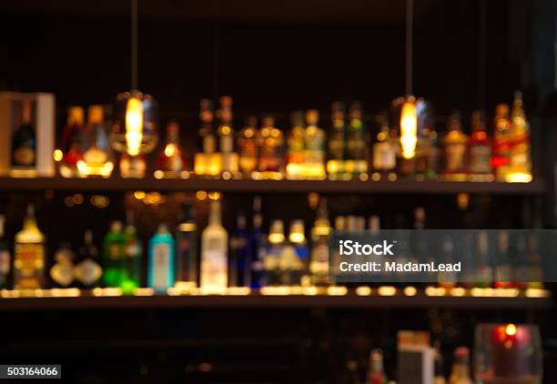 Blur Alcohol Drink Bottle At Pub In Dark Night Stock Photo - Download Image Now - Bar Counter, Bar - Drink Establishment, Bottle