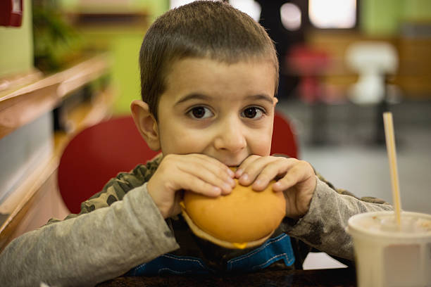 istock Boy eating fast food and enjoyoing it 503164416