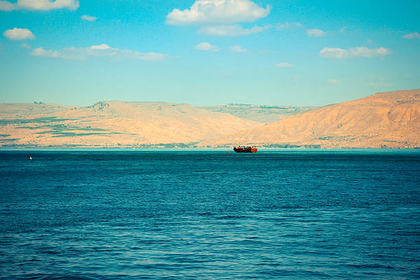 Brown wooden boat sailing in Sea of Galilee Brown wooden boat sailing in Sea of Galilee sea of galilee stock pictures, royalty-free photos & images