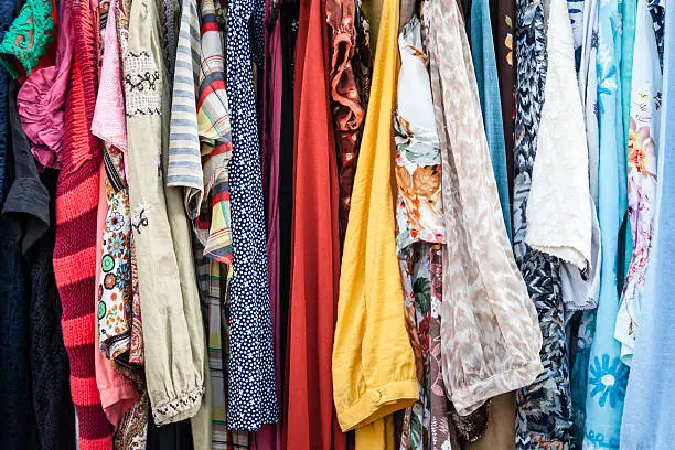 Bright and colorful rack of old vintage retro clothes for sale at a local market