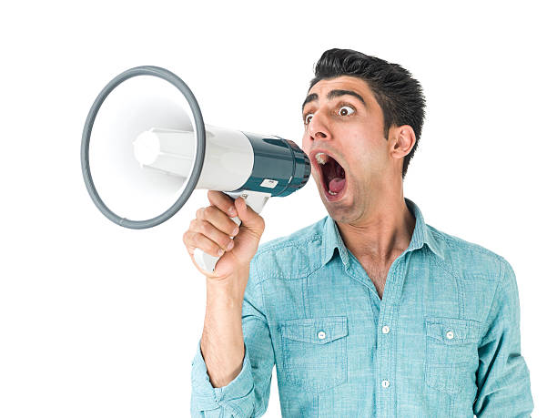 istock Young Man Wearing A Green Shirt Shouting On Red Megaphone 503170390