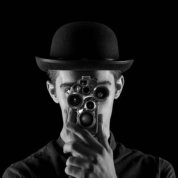 istock Young Man In Old Fashioned Style Filming Via Antique Camera 503170410