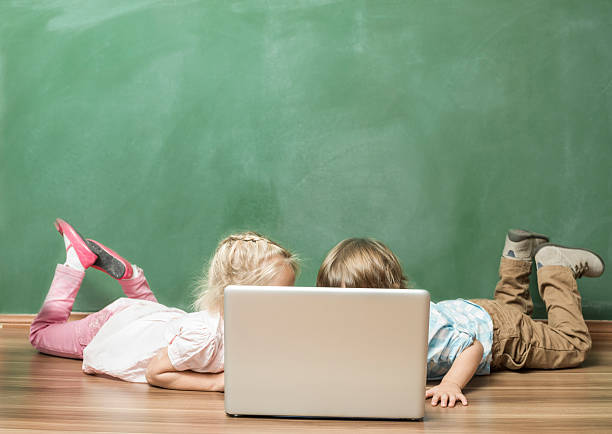 Indian sikh/Punjabi  boy and girl studying with books and laptop computer at study table