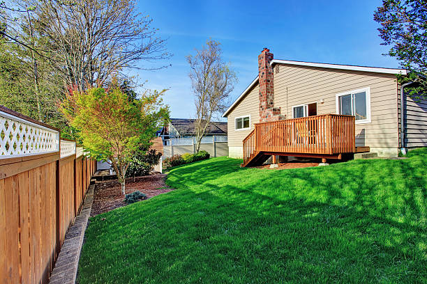 istock Cozy small backyard with wooden walkout deck 503173293