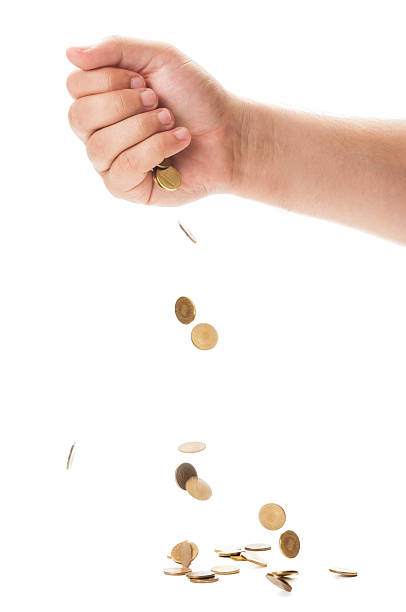 istock Hand dropping a bunch of golden coins 503174157