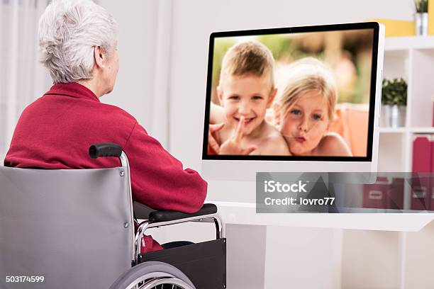 Grandmother Has A Video Call Stock Photo - Download Image Now - Computer Monitor, Grandchild, VoIP