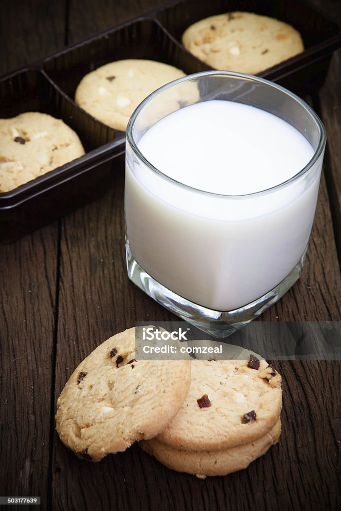 cookies and glass milk on wood table Backgrounds Stock Photo