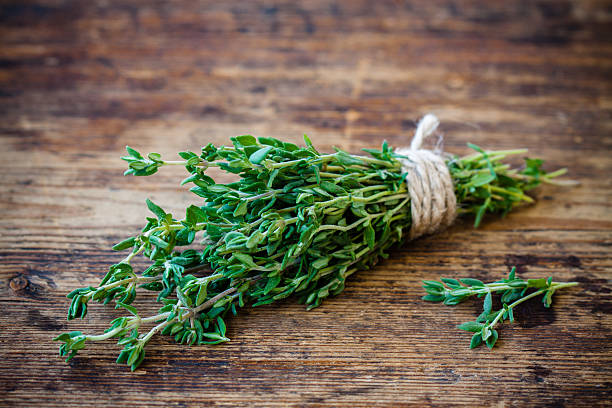 istock bunch of fresh thyme on a wooden background 503178063