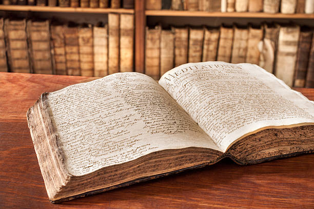 Opened vintage book in a library. 400 year old handwrite. Photo was taken at avaible light, and it is slightly toned to enhance the old condition of the books.