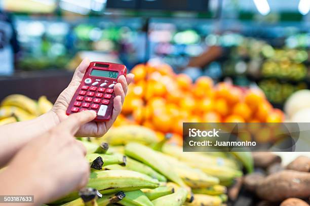 Using A Calculator At The Supermarket Stock Photo - Download Image Now - Inflation - Economics, Supermarket, Food