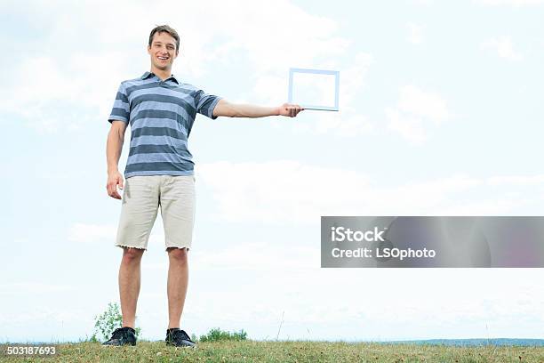 Grass Men Holding Frame Stock Photo - Download Image Now - 20-29 Years, Adult, Horizontal