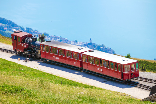St. Wolfgang, Austria - August 6, 2013: Steam train with red tourist railway carriages going to Schafberg Peak station, St. Wolfgang.