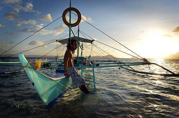 philippino с его традиционным banca аутригер лодки на филиппинах - outrigger philippines mindanao palawan стоковые фото и изображения