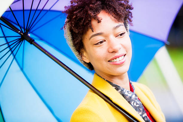 istock Beautiful multi-racial woman with umbrella 503189875