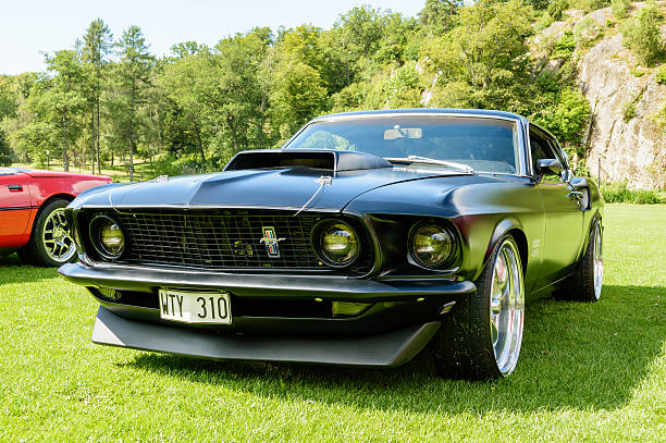 Mustang fastback 429 1969 Ronneby, Sweden - July 17, 2014: Press show for upcoming event "Pony and muscle car meet". Front and side view of black Mustang fastback 429 1969. 1969 stock pictures, royalty-free photos & images