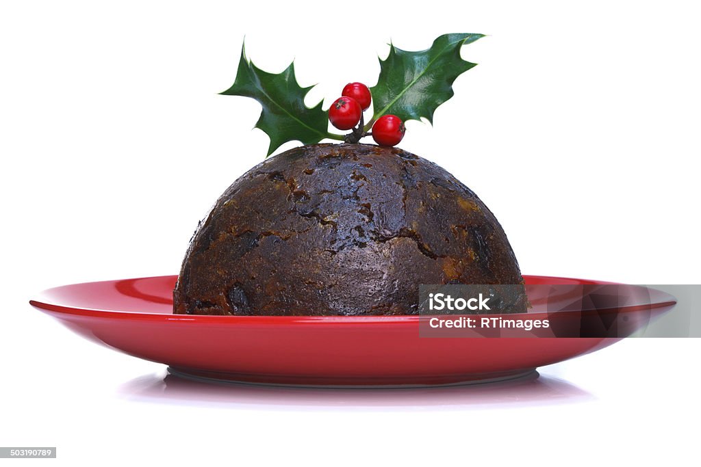 Christmas pudding isolated Photo of a steamed Christmas pudding with holly on top isolated on a white background. Christmas Pudding Stock Photo