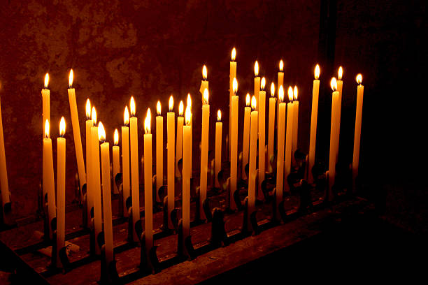 istock Candles burning into a church 503191254