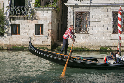 venice, italy - May 17, 2014: gondolier is riding traditional gondola at grand canal of venice italy