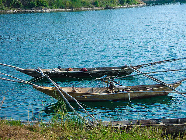 Outrigger Fishing boats along Shore Lake Kivu Rwanda Outrigger Fishing boats along Shore Lake Kivu Rwanda lake kivu stock pictures, royalty-free photos & images