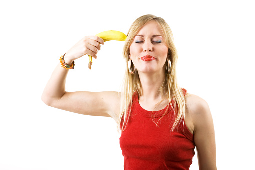 Woman pointing a banana like a gun against her head