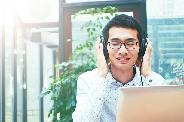 istock Young Asian man listening music 503192400