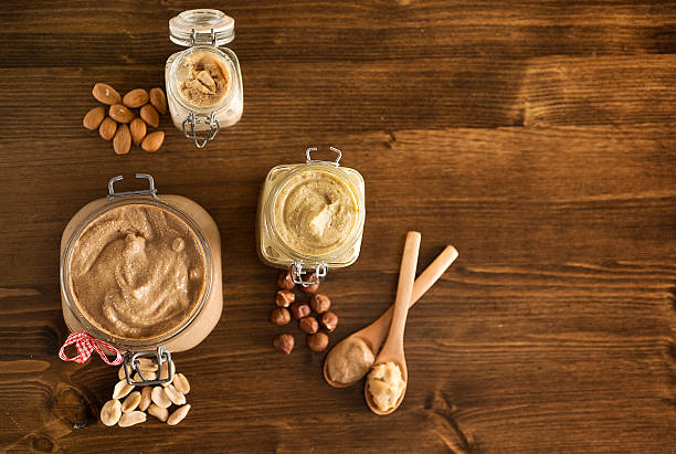Home made peanut butter and other kinds of nut butters stock photo