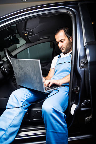 istock Young mechanic working on laptop to fix the car 503194237