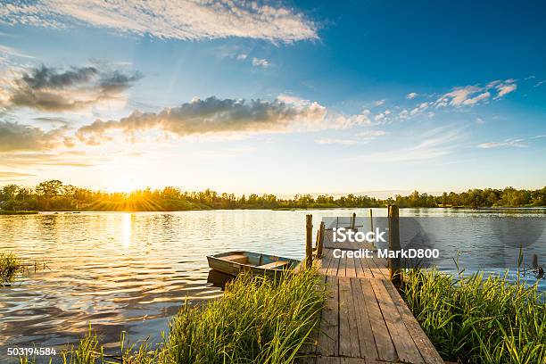 Sunset Over The Lake In The Village Stock Photo - Download Image Now - Lake, Pier, Jetty
