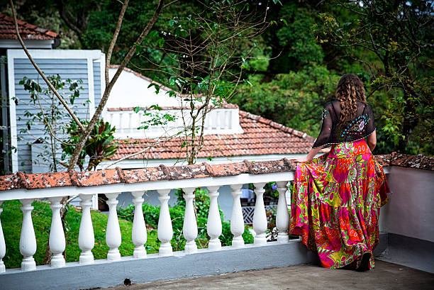 istock Woman standing on Balcony in Munnar. India 503196330